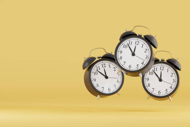 istock Black Friday Concept, Black Alarm Clocks on Yellow Background 2184699384
