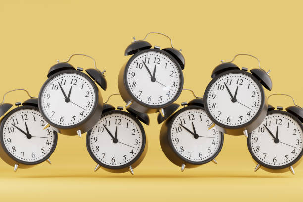 istock Black Friday Concept, Black Alarm Clocks on Yellow Background 2184699405