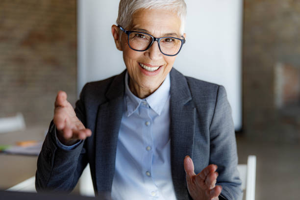 istock Happy mature entrepreneur talking during conference call. 2184699408