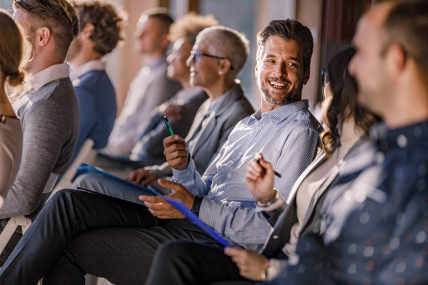 istock Happy entrepreneurs talking on a seminar in board room. 2184699662