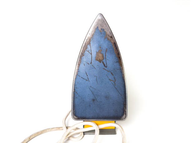 istock Close-up of an old, worn-out iron soleplate with visible scratches and burn marks. 2184700263