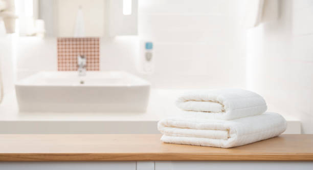 istock White folded spa towels on wooden table over blurred bathroom interior background 2184700929