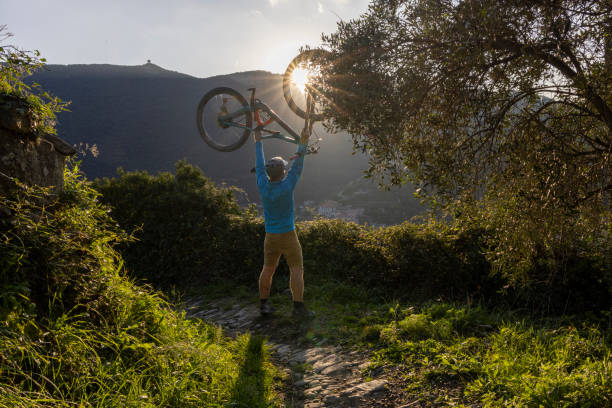 GIRL ON THE TOP OF A MOUNTAIN WITH HELMET AND GLOVES ON A MOUNTAIN BIKE