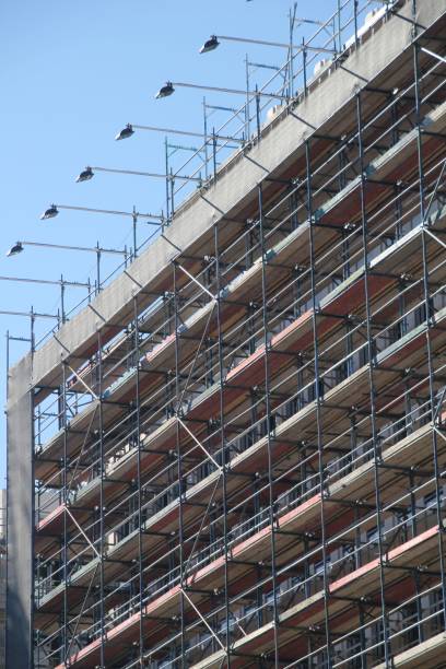 istock High-rise building scaffolding against a blue sky. 2184702213