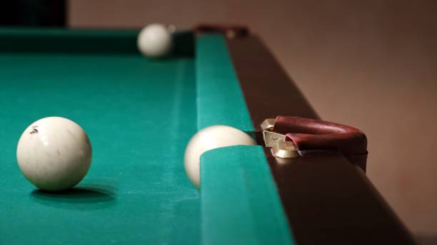 istock Playing Russian billiards on a green table. A white ball rolls and hits another which pockets into the pocket. A successful shot close up. Pastime at home playing sport game hobby. Nobody. Step 2 2184703389