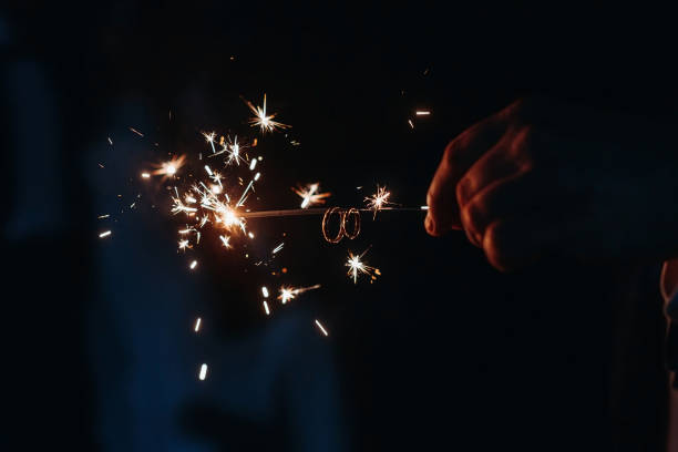 istock wedding rings on sparkler in hand 2184706263
