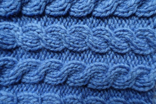 istock Surface of handmade blue knitted fabric with cable braids 2184706966