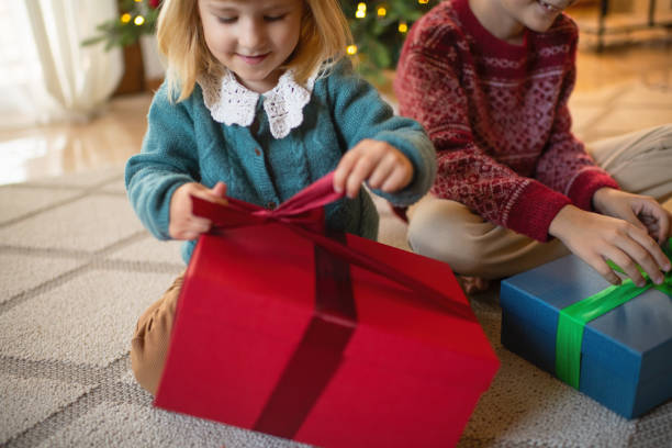 istock Happy children opening Christmas presents 2184707755