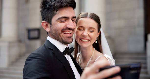 istock Couple, selfie and smile with wedding in city, love and care for commitment, memory and post on web. People, man and woman with marriage, event and happy for celebration on social network 2184712078
