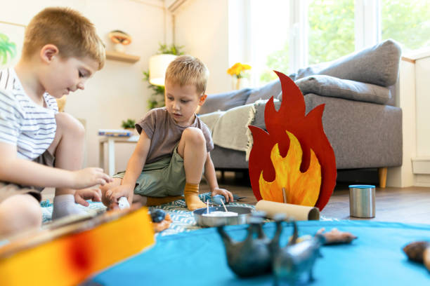 Two small mate, carton campfire and day for creative play indoor
