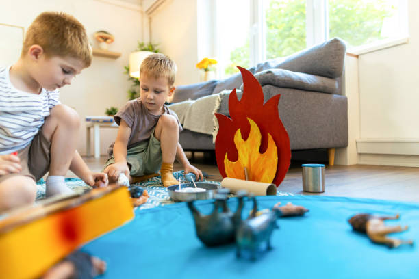 Two small mate, carton campfire and day for creative play indoor