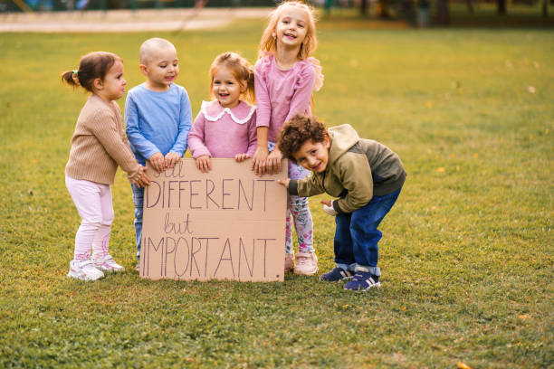 istock Children holding a sign All different but important 2184716082