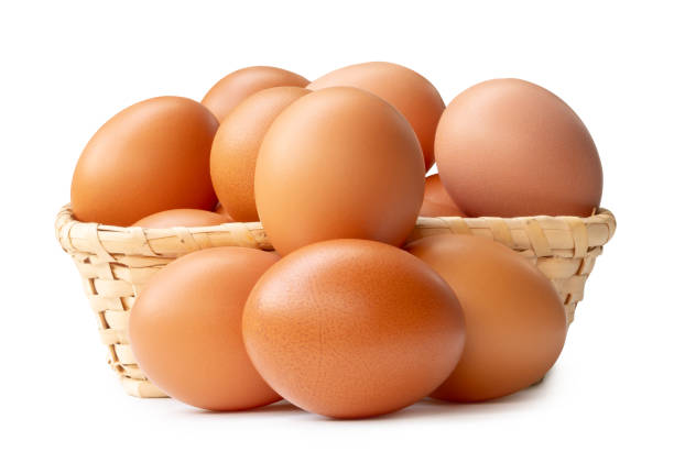 istock Group of fresh brown chicken eggs in stack in wicker basket isolated on white background with clipping path 2184719401