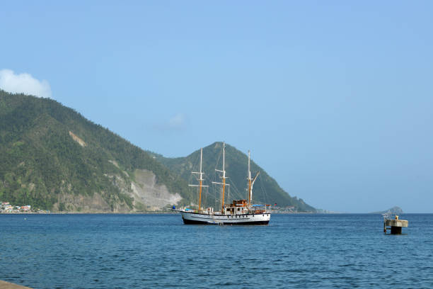 Roseau, Dominica: windjammer for adventure cruising, moored with Morne La Falaise and Morne La Vue mountains in the background.
