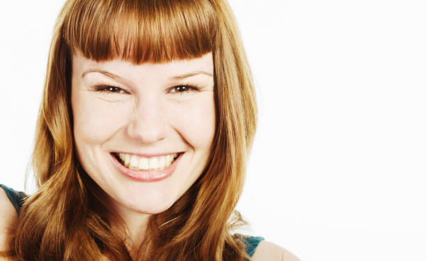 istock Beautiful redhead smiles broadly at the camera, looking delighted 2184720145