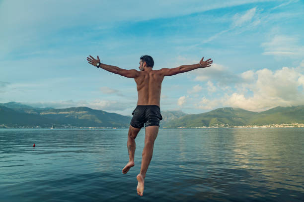 istock Man jumping in the sea 2184720634