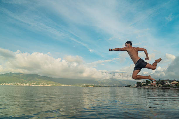 istock Man jumping in the sea 2184720636