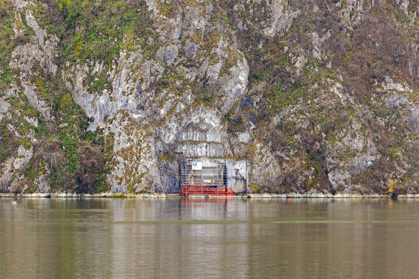 Tekija, Serbia - March 15, 2024: Trajan Plaque Historic Landmark Roman Relic in a Danube River Canyon Construction Scaffoldings.