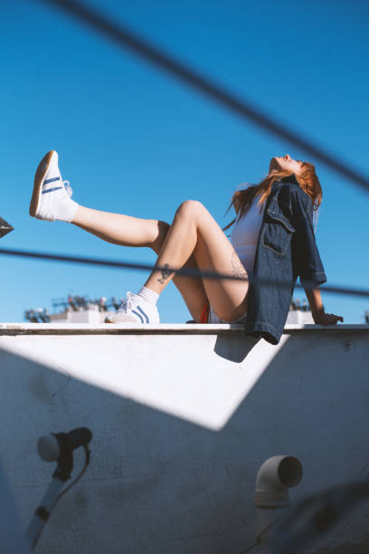 istock Cool Young Blonde Woman on a Rooftop 2184724140