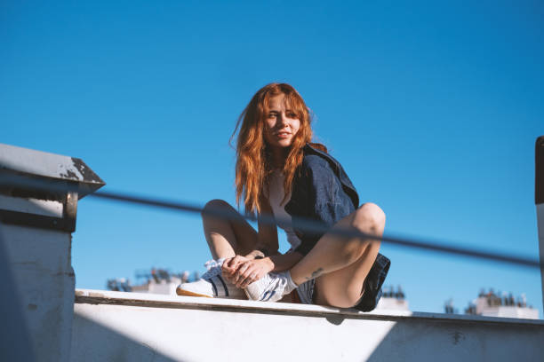 Portrait of a gorgeous young woman wearing a over size denim shirt.