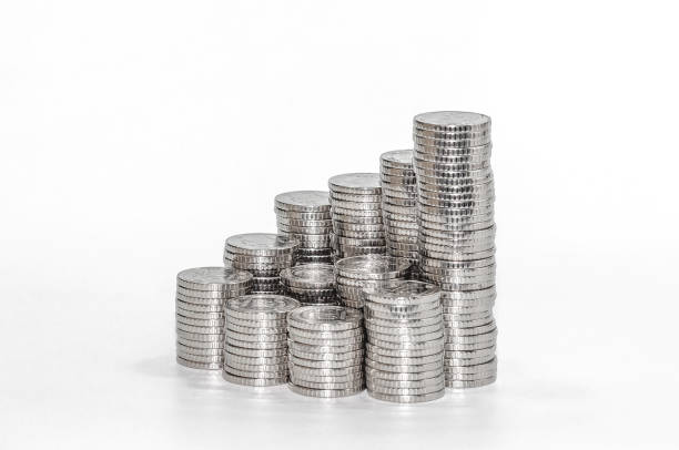 istock Stack of coins in row, stacked in pyramid. All coins silver and same size. Finance and savings background. 2184725663