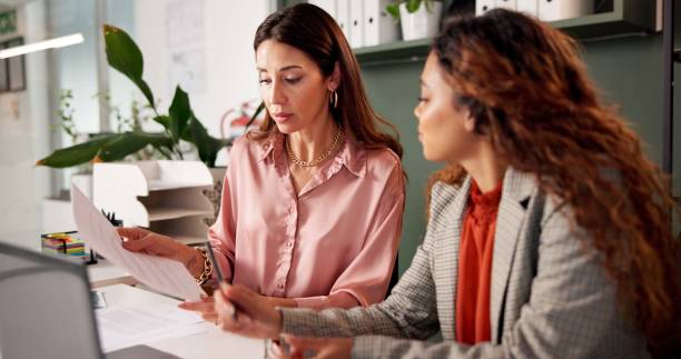 istock Office, reading and financial advisor with client for document, investment discussion and tips. Business meeting, women and planning with paperwork for policy review, guidance and corporate report 2184726557