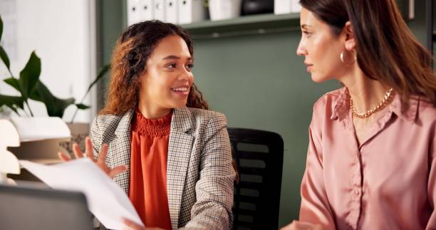 istock Meeting, talking and financial advisor with client for document, investment discussion and tips. Business office, women team and planning with paperwork for policy review, project report or corporate 2184726570