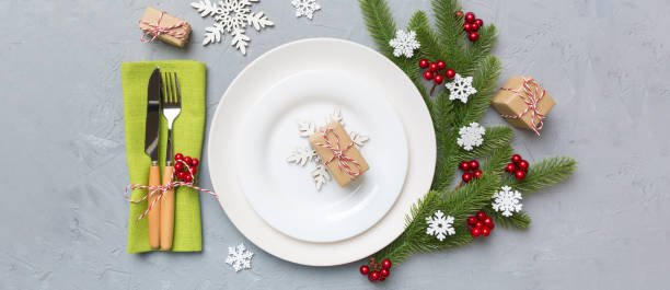 istock Christmas table place setting with christmas decor and plates, kine, fork and spoon. Christmas holiday background. Top view 2184726986