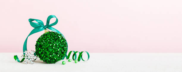 istock Christmas ball on colored background. decoration bauble with ribbon bow with copy space 2184727112