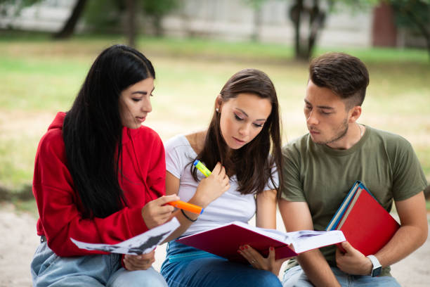 istock Three young adult students studying together in a university campus 2184727381