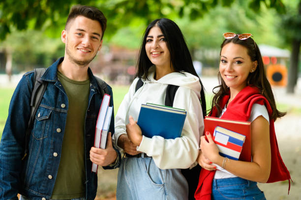 istock University students smiling and holding books on campus 2184727763
