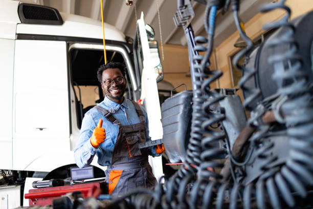 istock Truck serviceman with laptop computer repairing long vehicle. 2184728050