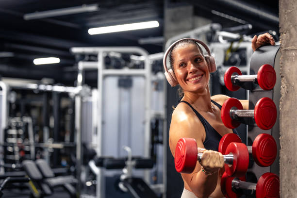 istock Female fitness instructor using weights in the gym. 2184728206