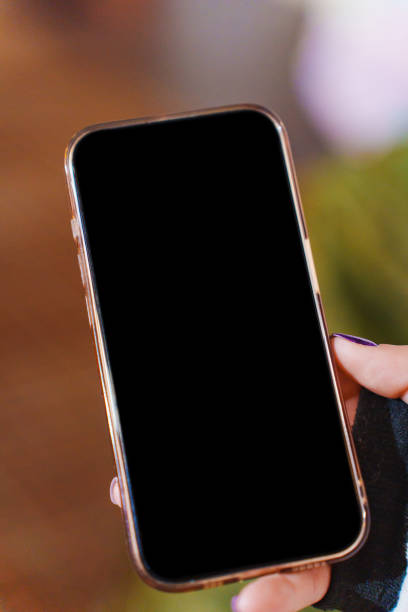 istock A smartphone with a blank black screen in a woman's hand. 2184731093
