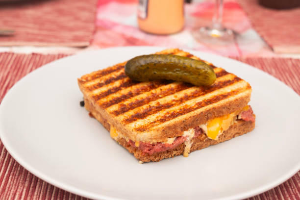 Delicious Reuben sandwich with pastrami ham from species-appropriate animal husbandry, sauerkraut and organic cheddar cheese on multigrain toasted sandwich bread.