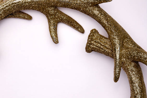 Decorative antlers adorned with glitter create a charming accent for winter holiday decorations in any home.