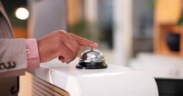 istock Hands, hotel and bell ring at reception with waiting for assistance, customer service and concierge help. Hospitality, lobby and booking of person with noise for attention, support and call for staff 2184735174