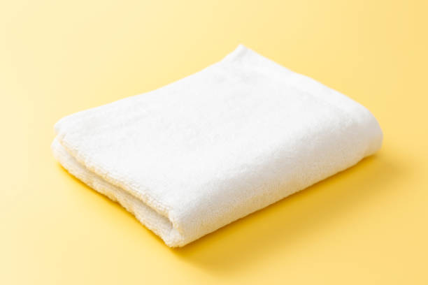 istock White towel on a yellow background 2184741647