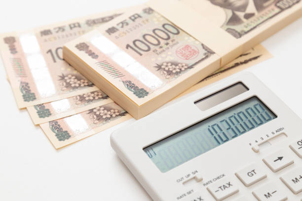 1,030,000 yen and a calculator on a white background.The 1.03 million yen barrier.Japan's tax system.Spouse deduction.
