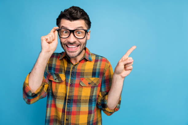 istock Photo of ecstatic cheerful man staring touching glasses directing empty space unbelievable discount isolated on blue color background 2184749359