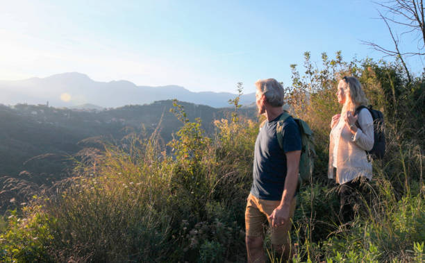 istock Mature couple look across hills to setting sun 2184751206