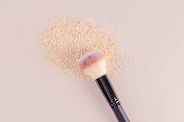 istock Natural tone decorative loose powder and make up brush on a beige background. layout for design. template. A copy space. Care and beauty concept. 2184754309