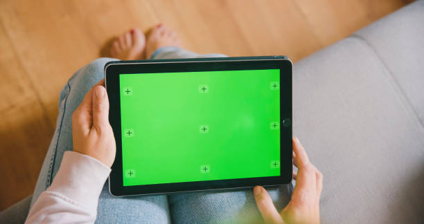 istock Mid Adult Woman Engages with Tablet on Sofa 2184756482