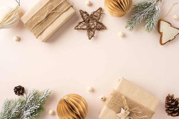 istock A festive flat lay featuring rustic Christmas gifts wrapped in natural paper, surrounded by pine cones, ornaments, and greenery on a neutral background 2184757104