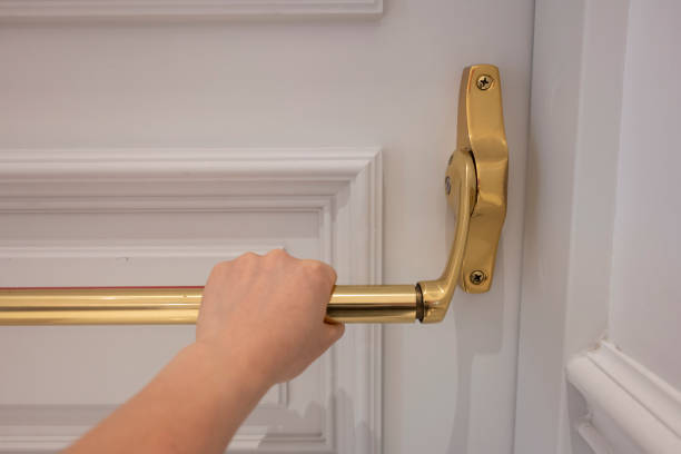 istock Hand pulling the golden handle of the white wooden door 2184758207