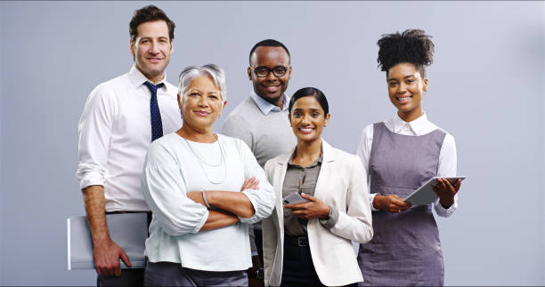istock Business people, portrait and studio for group solidarity, collaboration and tech on gray background. Employees, diversity and support staff in company, about us and together for finance mission 2184761747