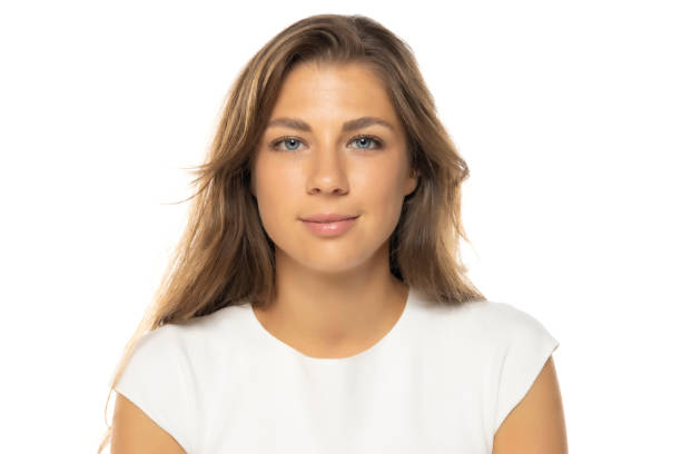 istock Portrait of young smiling woman with a light makeup on a white studio background. 2184762675