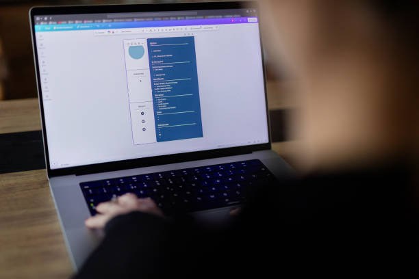 istock Woman creating her CV on computer. All contents in document are made up 2184763393
