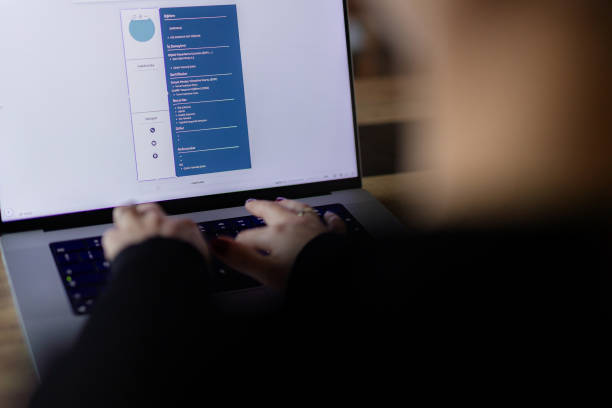 Woman creating her CV on computer. All contents in document are made up