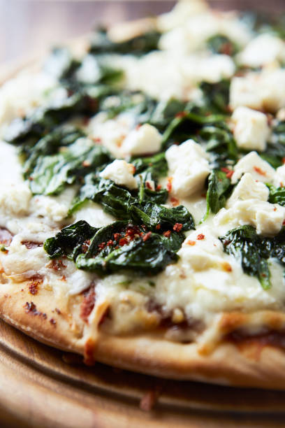 istock Pizza with mozzarella cheese and spinach. Dark wooden background. Close up. 2184765223